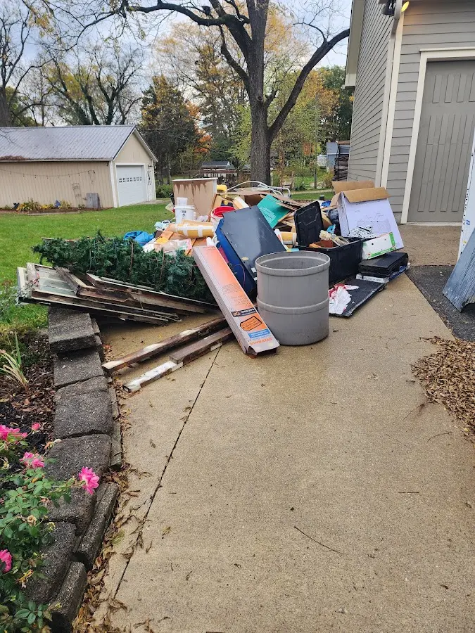Dumpster being loaded with debris for Estate Cleanout Dumpster Rental in Nesquehoning